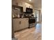 Modern kitchen features stainless steel appliances, tile backsplash, wood-look floors, and ample counter space at 1055 Worthington Hills Dr, Roswell, GA 30076