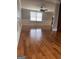 An empty living room features hardwood floors, paneled walls, a ceiling fan and natural light at 1055 Worthington Hills Dr, Roswell, GA 30076