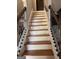 A well-lit staircase features stained wood treads, white risers, and decorative black iron railings at 1055 Worthington Hills Dr, Roswell, GA 30076