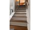 Staircase with stained wood treads and white risers with a white railing at 1055 Worthington Hills Dr, Roswell, GA 30076