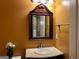Powder room with a decorative mirror, and pedestal sink at 1218 Heartwood Ave, Mcdonough, GA 30253