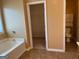 Bathroom with a shower-tub combination, walk-in closet and toilet at 1218 Heartwood Ave, Mcdonough, GA 30253