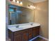 Bathroom featuring a double sink vanity, granite countertop, wood cabinets and tile floors at 1218 Heartwood Ave, Mcdonough, GA 30253