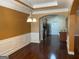 Open dining room view to kitchen with modern chandelier and hardwood floors at 1218 Heartwood Ave, Mcdonough, GA 30253