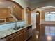 Kitchen and dining area featuring granite countertops, hardwood floors and stainless steel appliances at 1218 Heartwood Ave, Mcdonough, GA 30253