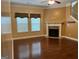 Bright living room with hardwood floors and a fireplace at 1218 Heartwood Ave, Mcdonough, GA 30253