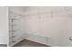 Walk-in closet with multiple shelves and carpeted floor at 1218 Heartwood Ave, Mcdonough, GA 30253