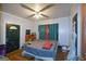 Bedroom featuring hardwood floors, ceiling fan, and curtains covering the windows for privacy at 1660 Rogers Sw Ave, Atlanta, GA 30310