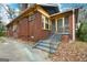Brick house exterior featuring a staircase leading to a cozy, screened porch, complete with foliage at 1660 Rogers Sw Ave, Atlanta, GA 30310