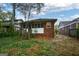 Charming bungalow featuring brick accents, a screened porch, and a lush front yard at 1660 Rogers Sw Ave, Atlanta, GA 30310