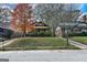 A charming brick home with a cozy, screened front porch complemented by the beauty of autumn foliage at 1660 Rogers Sw Ave, Atlanta, GA 30310