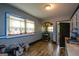 Eat-in kitchen area featuring blue cabinets, mosaic backsplash, and linoleum floors at 1660 Rogers Sw Ave, Atlanta, GA 30310
