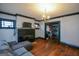 Cozy living room featuring hardwood floors, a painted brick fireplace, and a large comfortable sofa at 1660 Rogers Sw Ave, Atlanta, GA 30310