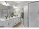 Bathroom with a long double sink vanity, decorative mirror and a stand up shower at 175 N Unity Grove Rd, Locust Grove, GA 30248