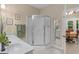 Bright bathroom featuring dual sink vanity and stand up shower, with view into dining room at 175 N Unity Grove Rd, Locust Grove, GA 30248