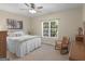Cozy bedroom with a comfortable bed, rocking chair, and plenty of natural light from the window at 175 N Unity Grove Rd, Locust Grove, GA 30248