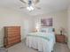 Bedroom with neutral walls, a ceiling fan, a bed with a light blue cover, and wood furniture at 175 N Unity Grove Rd, Locust Grove, GA 30248