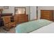 Comfortable bedroom showcasing neutral walls, wooden dresser, and natural light at 175 N Unity Grove Rd, Locust Grove, GA 30248