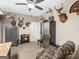 Bedroom with a ceiling fan, a gun safe, a bookshelf, and a camouflage chair at 175 N Unity Grove Rd, Locust Grove, GA 30248