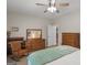 Bedroom with neutral walls, a ceiling fan, a bed with a light blue cover, and a rocking chair at 175 N Unity Grove Rd, Locust Grove, GA 30248