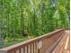 Wooden deck overlooking a wooded area behind the home at 175 N Unity Grove Rd, Locust Grove, GA 30248
