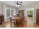 Cozy dining room with a wooden table, hardwood floors, natural light, and backyard view through a large window at 175 N Unity Grove Rd, Locust Grove, GA 30248
