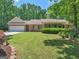 Landscaped front lawn with a two-car garage and covered porch of single-story brick home at 175 N Unity Grove Rd, Locust Grove, GA 30248