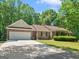 Charming single-story brick home featuring a two-car garage and well-manicured front lawn at 175 N Unity Grove Rd, Locust Grove, GA 30248