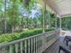 View of the front porch of the home with scenic trees and bushes at 175 N Unity Grove Rd, Locust Grove, GA 30248