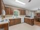 Spacious kitchen featuring wood cabinetry, white appliances, and a large window over the sink at 175 N Unity Grove Rd, Locust Grove, GA 30248