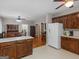 Open kitchen with wood cabinets that flows into a dining and living area at 175 N Unity Grove Rd, Locust Grove, GA 30248
