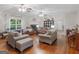 Spacious living room featuring hardwood floors, a fireplace, and large windows providing lots of natural light at 175 N Unity Grove Rd, Locust Grove, GA 30248