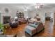 Spacious living room with hardwood floors, a fireplace, comfortable seating, and a ceiling fan at 175 N Unity Grove Rd, Locust Grove, GA 30248