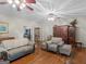 Cozy living room with hardwood floors, ceiling fans, and ample seating, including two comfortable couches at 175 N Unity Grove Rd, Locust Grove, GA 30248