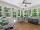 This sun room features bright light with windows all around and a wooden floor at 175 N Unity Grove Rd, Locust Grove, GA 30248