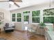 This sun room features bright light with windows all around and a wooden floor at 175 N Unity Grove Rd, Locust Grove, GA 30248