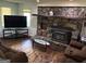 Inviting living room with hardwood floors, comfortable seating, and a striking stone fireplace at 2497 Old Jackson Rd, Locust Grove, GA 30248