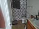Standard bathroom features a toilet, shower with patterned shower curtain and a sink with vanity at 11950 Markham Way, Hampton, GA 30228