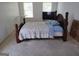 Cozy bedroom featuring a wooden bed frame, neutral carpet, and bright natural light at 11950 Markham Way, Hampton, GA 30228