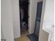 Walk-in closet with clothes, storage boxes and shelf; tile floor; and a shelf near doorway at 11950 Markham Way, Hampton, GA 30228