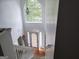 Bright foyer with tall window, white walls, hardwood floor, and grand staircase at 11950 Markham Way, Hampton, GA 30228