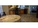 Kitchen featuring a dining table, oak cabinets, black appliances, and access to another room at 11950 Markham Way, Hampton, GA 30228