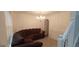 Elegant living room featuring a brown sofa, wall paneling, and decorative chandelier at 11950 Markham Way, Hampton, GA 30228