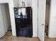Practical pantry area next to black refrigerator. Door open to storage shelves at 11950 Markham Way, Hampton, GA 30228