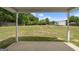 View of the backyard from a covered patio with a shed in the background at 100 Gum Creek Landing, Oxford, GA 30054