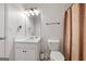 Bathroom with white fixtures, a vanity, a toilet, and a shower with a patterned curtain at 100 Gum Creek Landing, Oxford, GA 30054