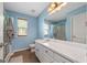 Powder blue bathroom with white vanity, a framed mirror and a shower with glass door at 100 Gum Creek Landing, Oxford, GA 30054
