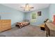 Cozy bedroom with neutral walls and carpet, ceiling fan, and a window offering natural light at 100 Gum Creek Landing, Oxford, GA 30054