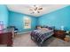 Bedroom with blue walls, a ceiling fan, a window with blinds, and carpeted floors at 100 Gum Creek Landing, Oxford, GA 30054