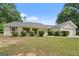 Traditional ranch home with a manicured lawn and mature landscaping at 100 Gum Creek Landing, Oxford, GA 30054